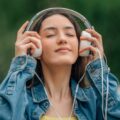 Relaxed,Girl,Enjoying,Outdoors,With,Headphones